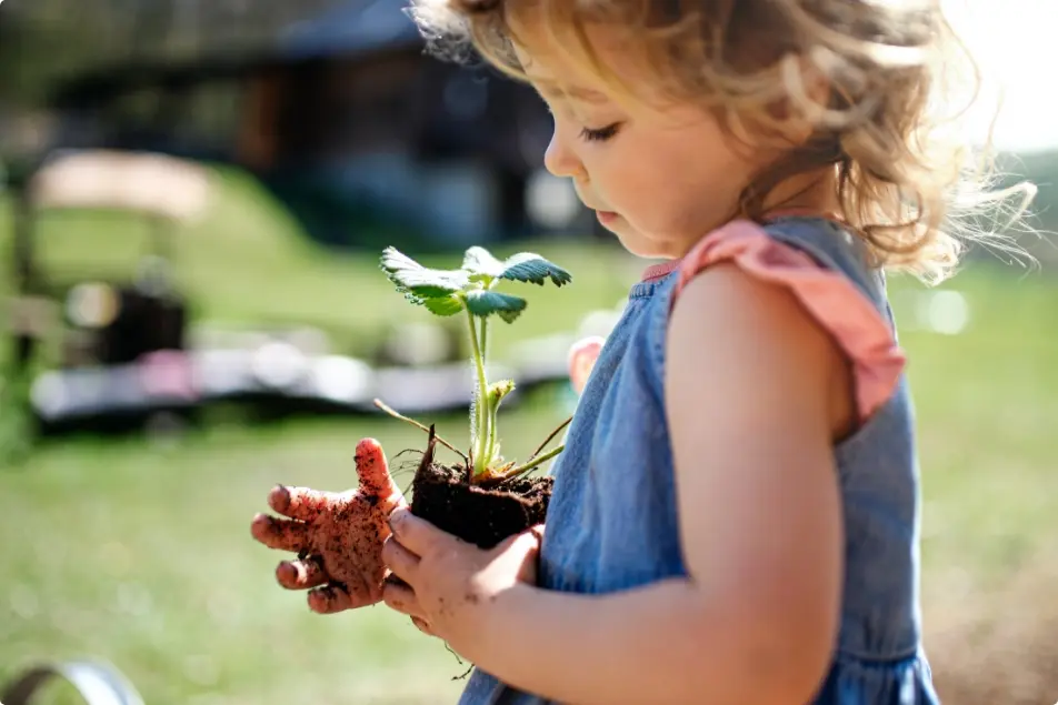 child-with-plant-in-hands