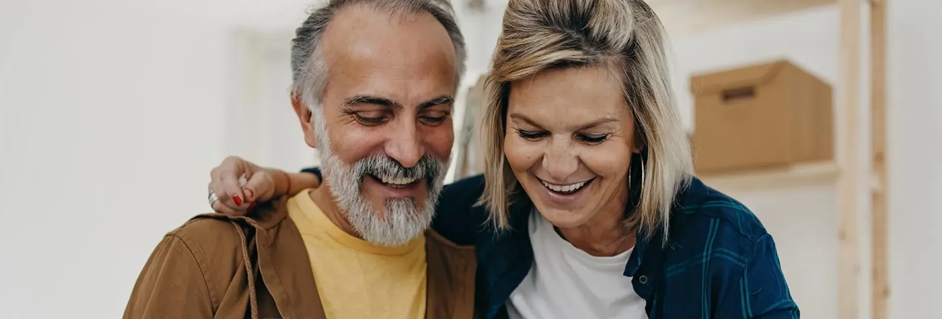 elderly-couple-smiling-while-going-through-cards