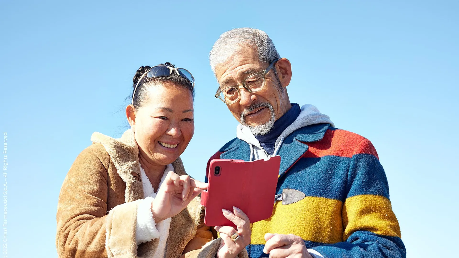 two-elders-smiling-watching-a-phone