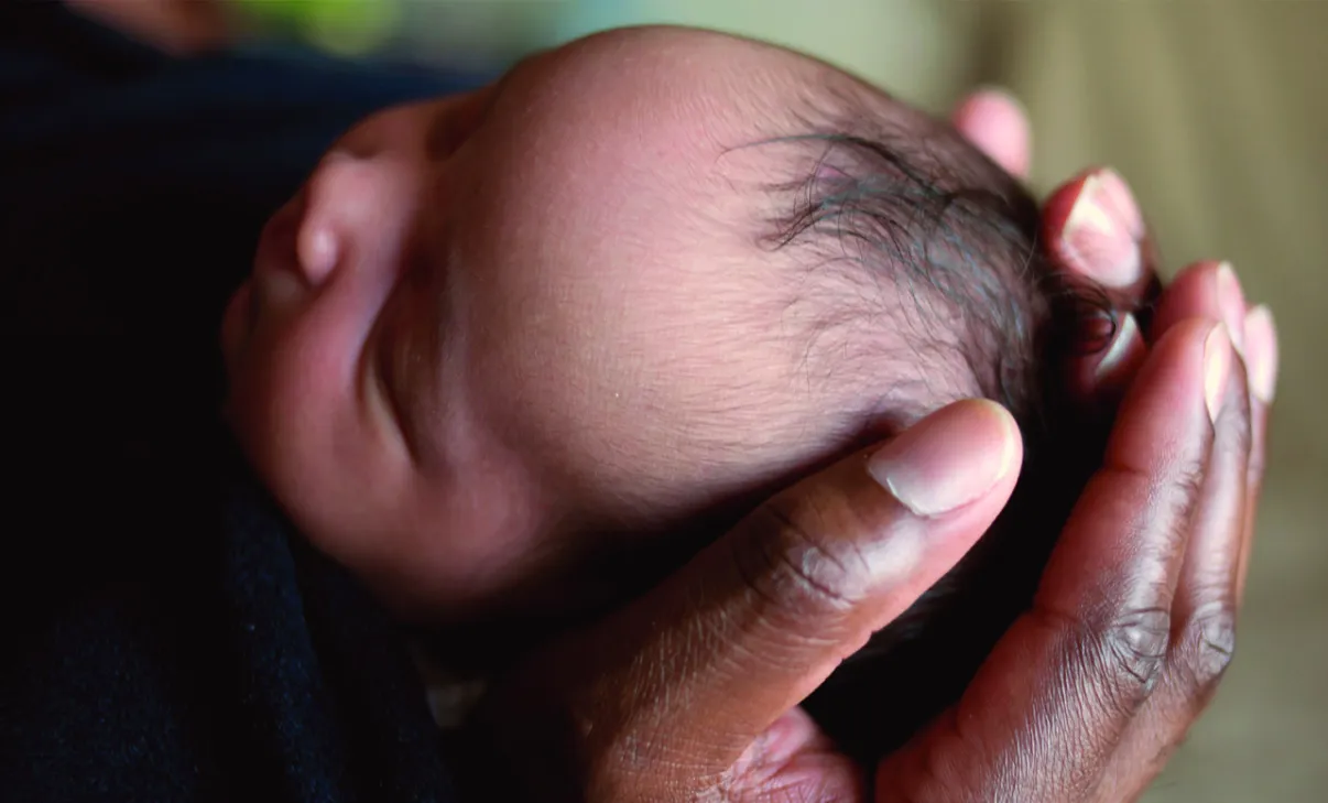 woman-holding-baby-head