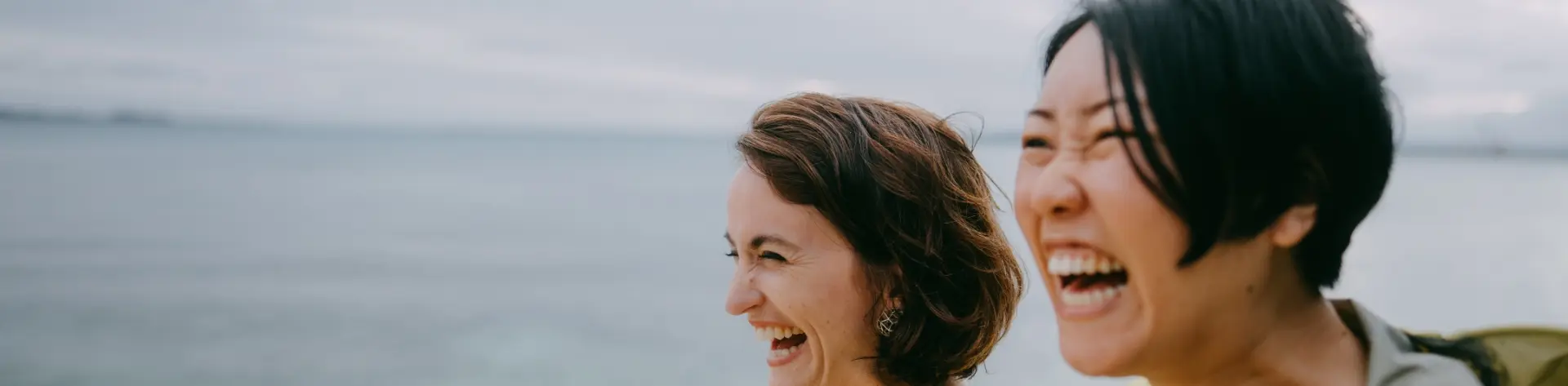 women-smiling-on-the-beach-banner