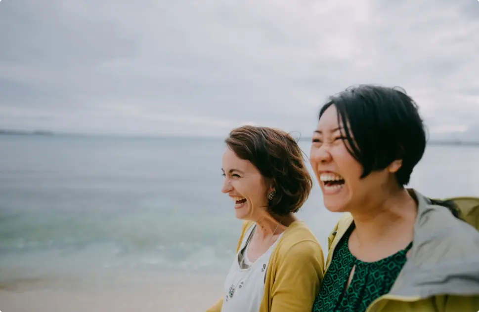 women-smiling-on-the-beach